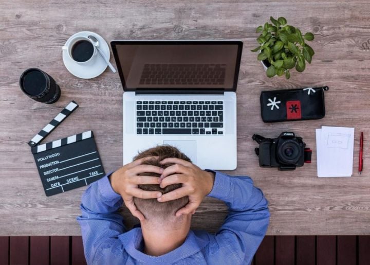 stressed employee sitting in front of a laptop