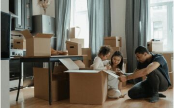 couple with young child packing for a move