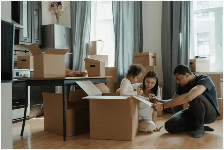 couple with young child packing for a move