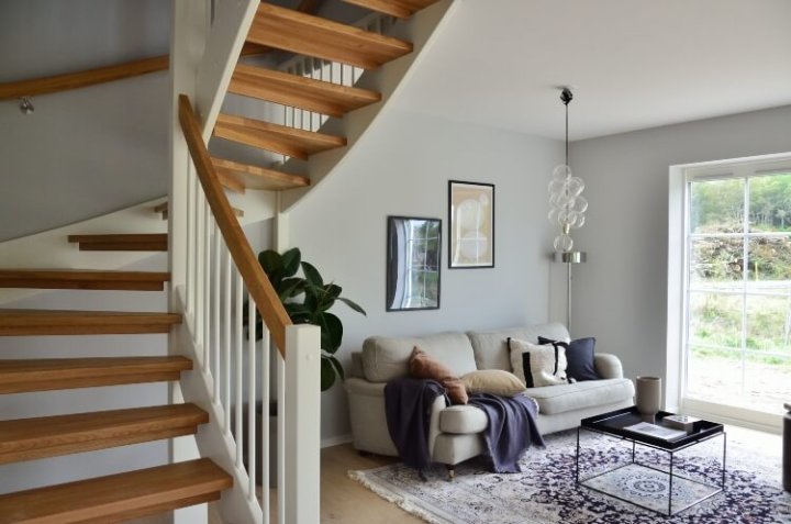 living area with large window and stairway