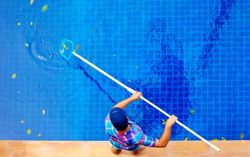 removing leaves from surface of pool