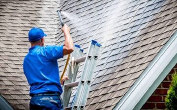 worker spraying a roof