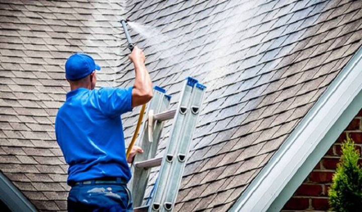 worker spraying a roof