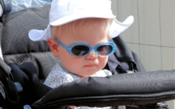 baby in carseat wearing sunglasses