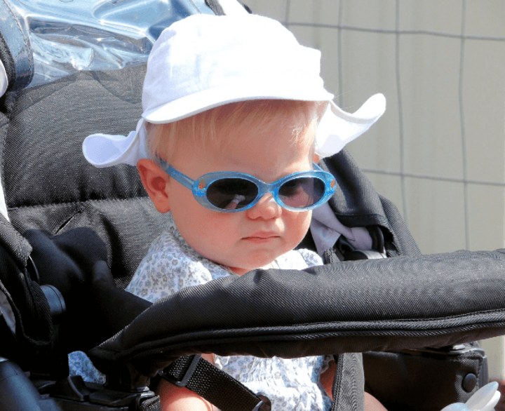 baby in carseat wearing sunglasses