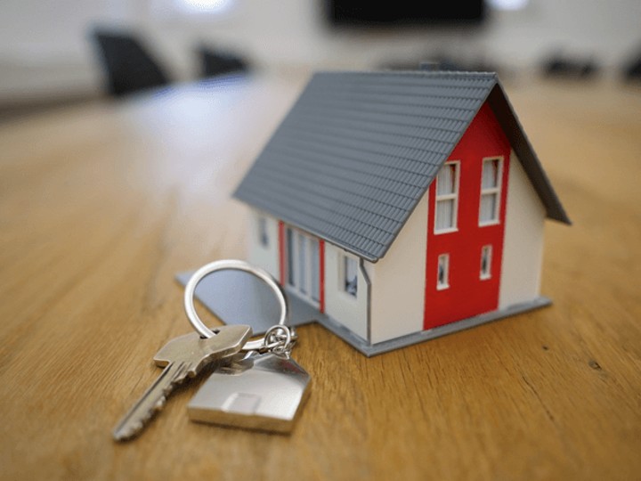 model of a house with key in front