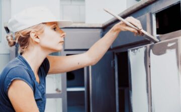 woman painting kitchen cabinets