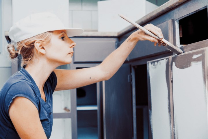 woman painting kitchen cabinets