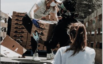 young women loading boxes onto a flatbed truck