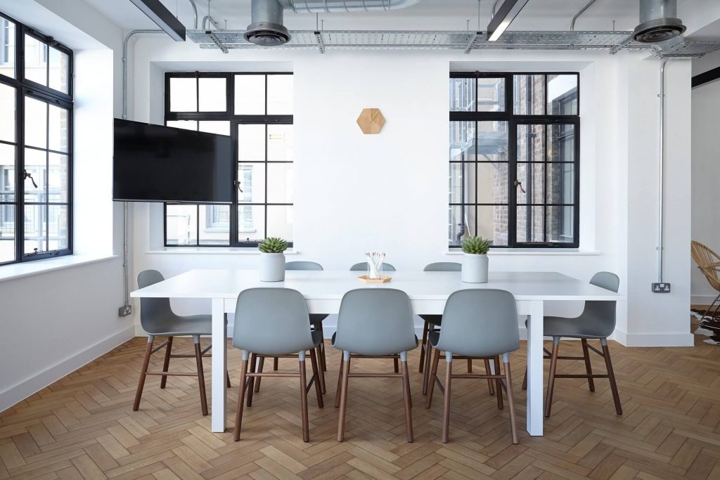 small conference area with table, chairs, and TV