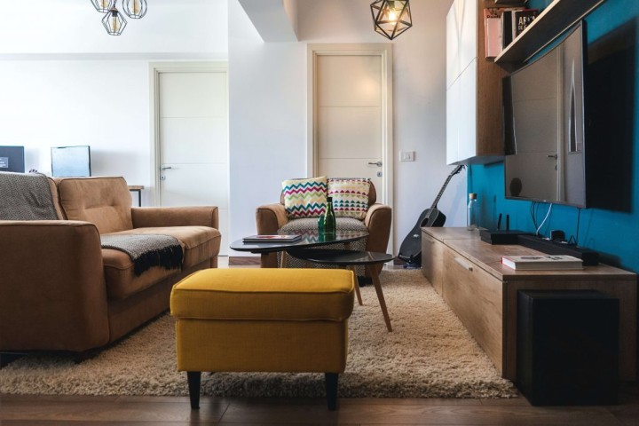 living room with maroon sofa and carpet