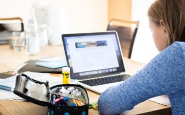 young girl studying on a laptop