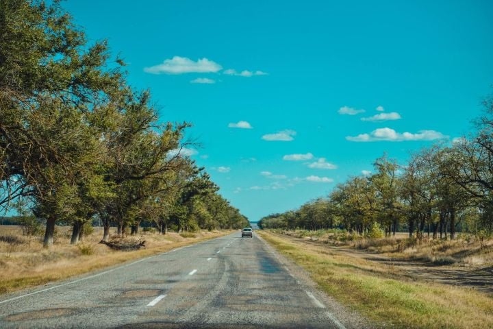 Long road leading off to a new home for someone moving across the country