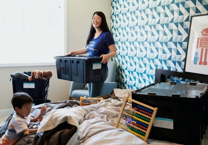 woman and young child packing boxes