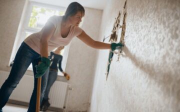 young woman tearing down a wall