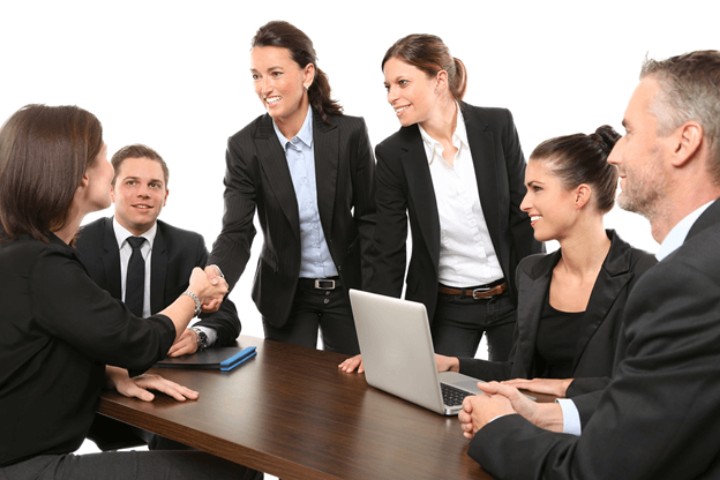 group of business people in dark suits shaking hands