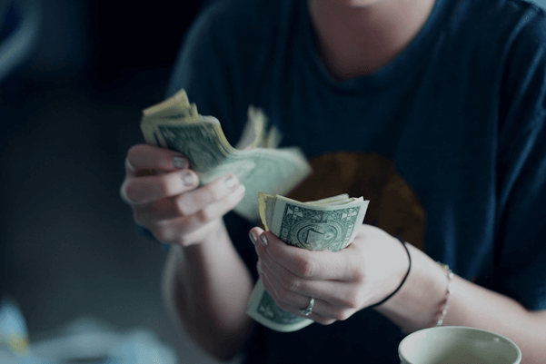 young woman counting dollar bills