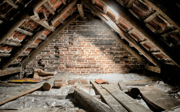Attic space under renovation in a home that needs roof repairs