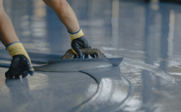 Warehouse floor being coated by a professional contractor