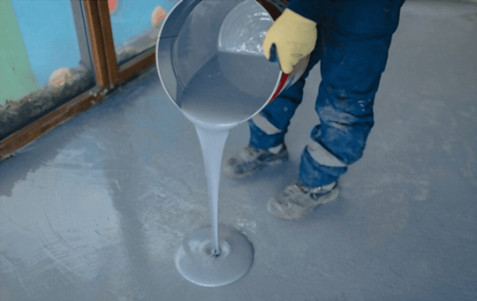 pouring floor coating on a floor