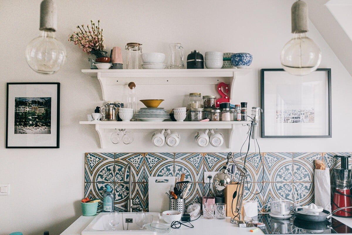 wall with colored backsplash and shelves above it