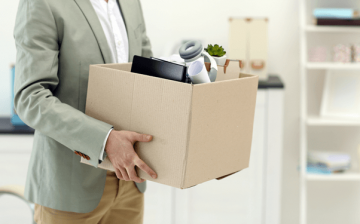 Office worker relocating to another job with a box of his possessions
