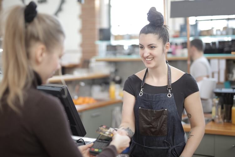 young woman making a credit card purchase in a store