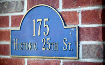 blue sign on brick wall