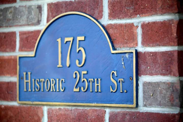 blue sign on brick wall