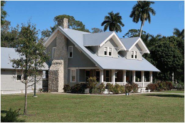 angle view of two-story house with chimney and blue roof