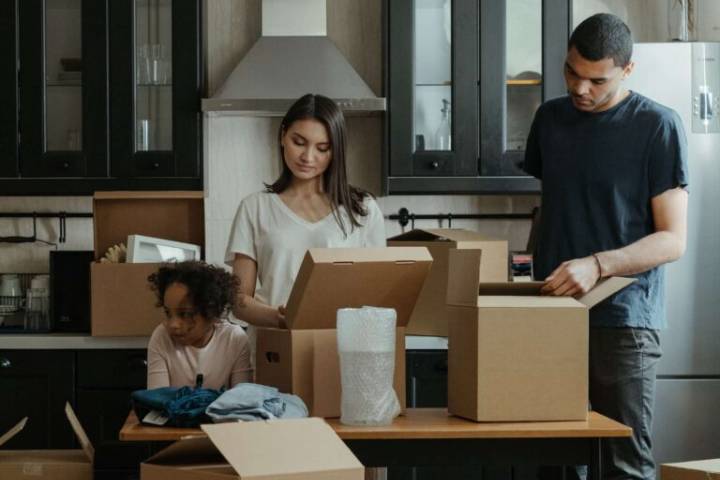 family unpacking boxes while moving