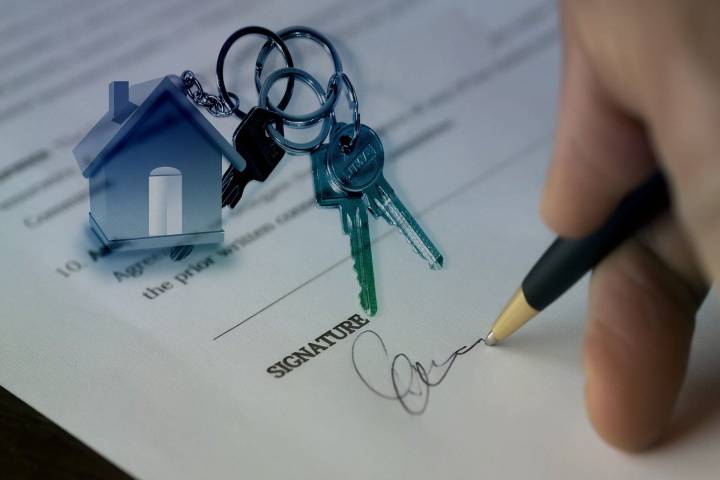 hand signing house purchase contract