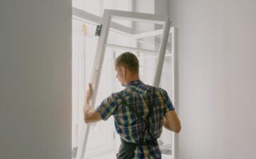 man placing window