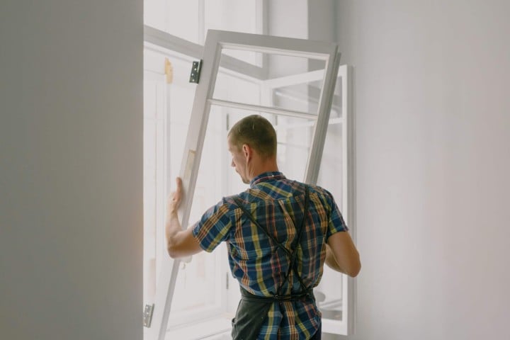 man placing window