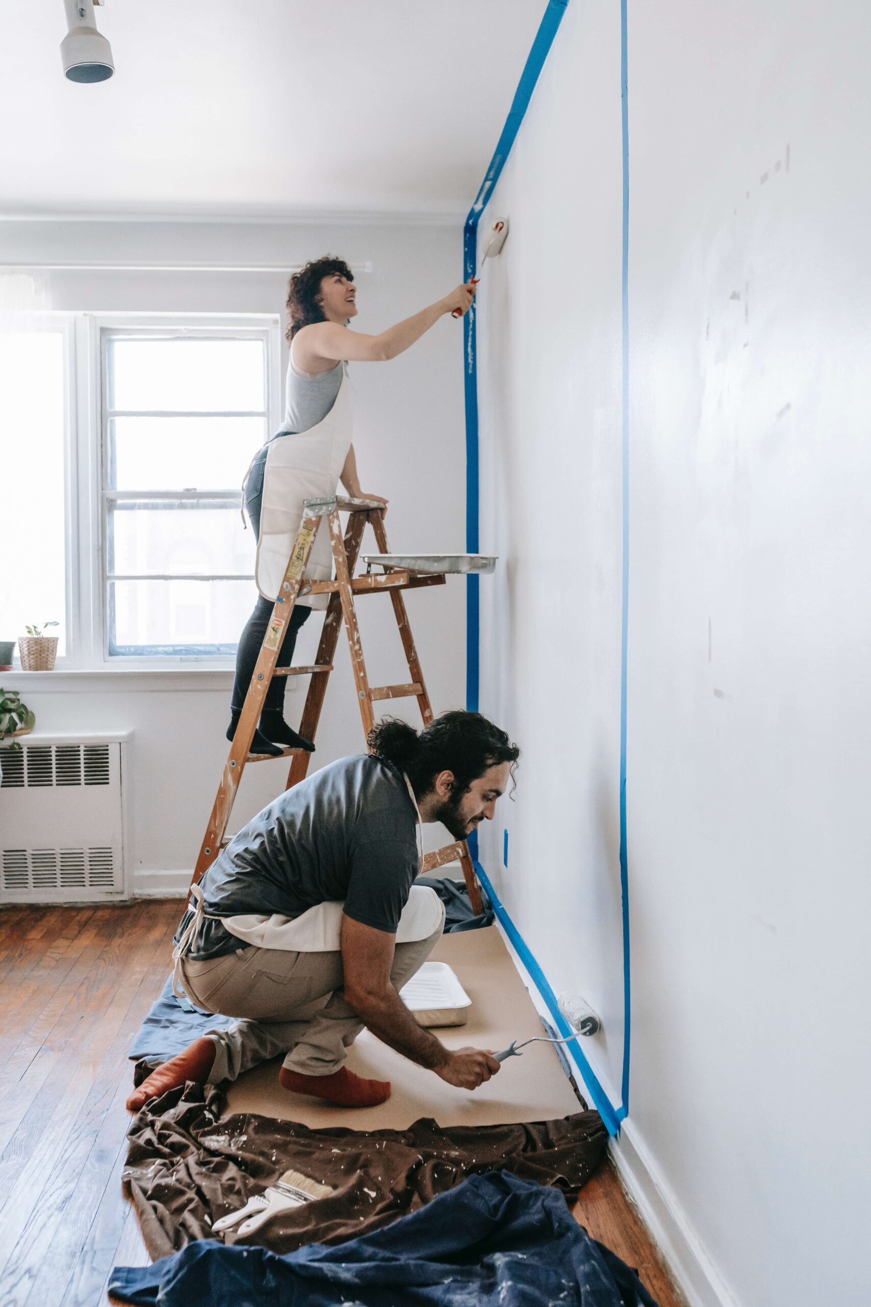 couple painting a wall in their home