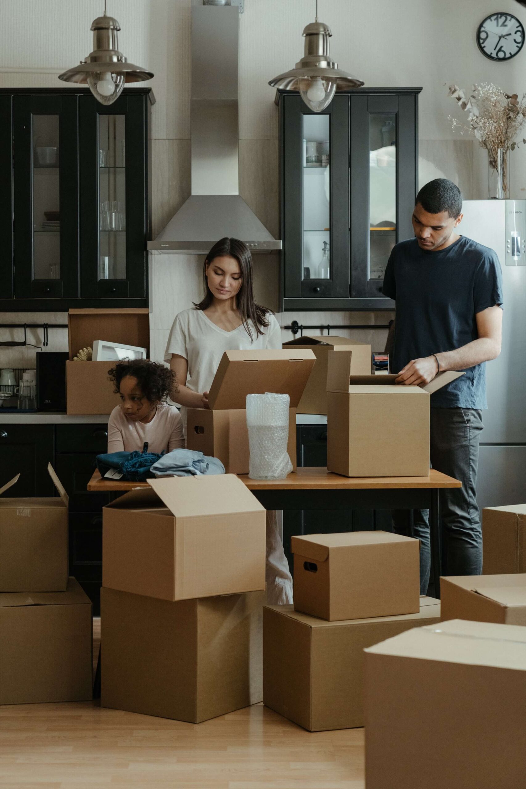 young couple and child with moving boxes