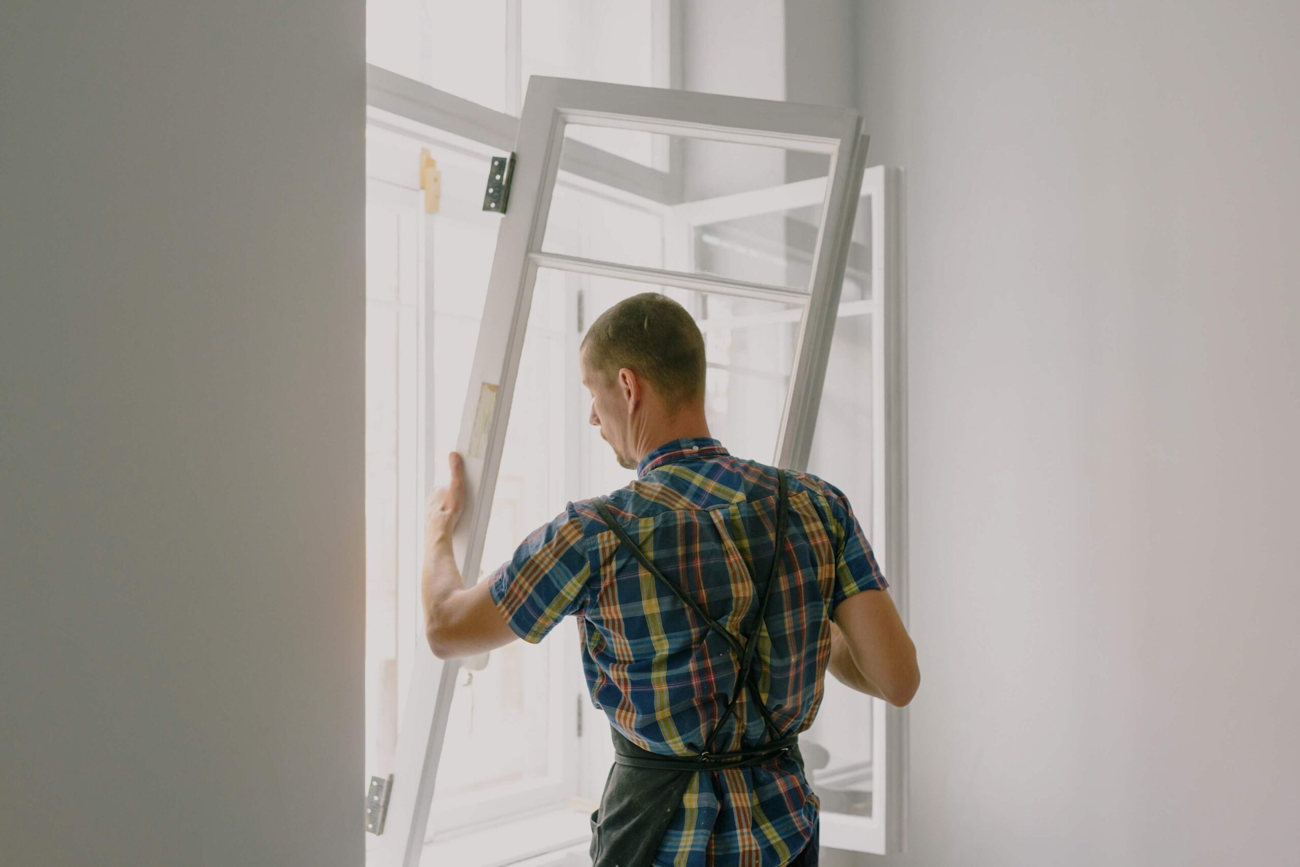 window installer putting a window in place