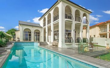 Luxury home with a large swimming pool and tall windows