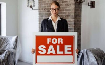 real estate woman with for sale sign