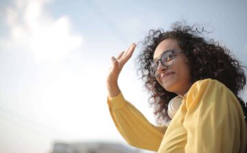 woman with glasses dressed in yellow