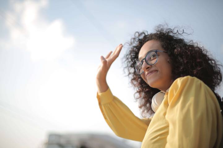 woman with glasses dressed in yellow