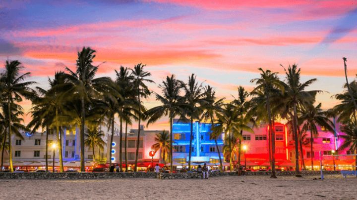colorfully lit Miami beachfront properties at dusk