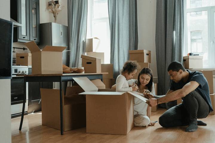 family labeling moving boxes