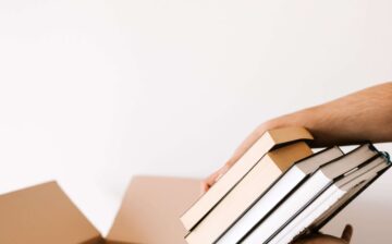 Packing books in a moving box