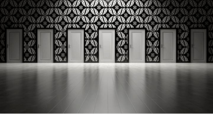 row of doors with wallpaper pattern on wall in gray colors