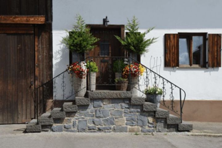 house door with stairs and plants