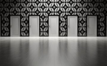 room with several doors in black and white