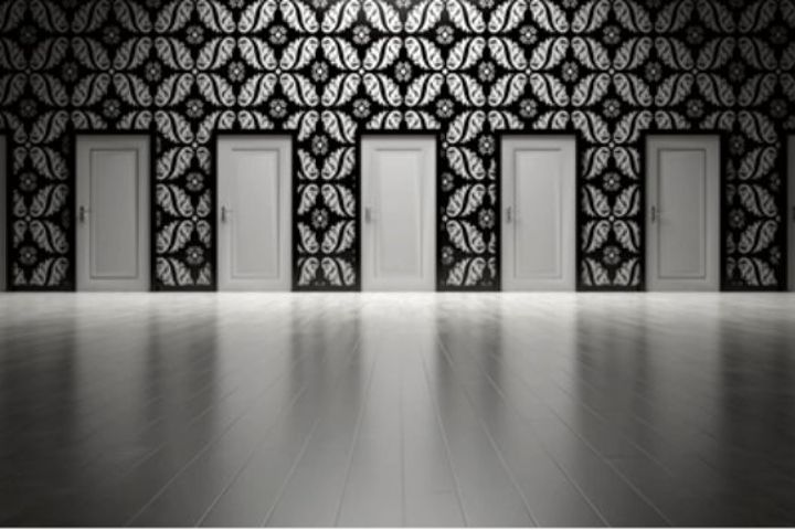 room with several doors in black and white