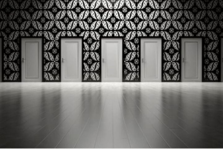 room with several doors in black and white