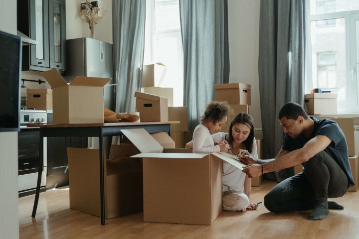 family preparing moving boxes